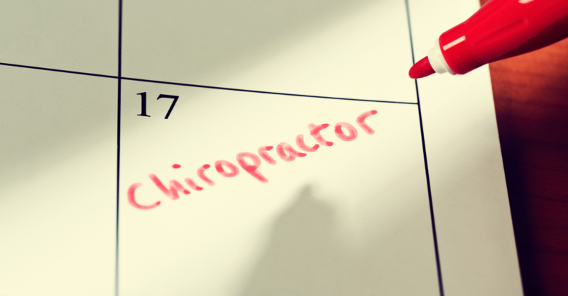 Close-up of a calendar with 'Chiropractor' written in red marker on the 17th, indicating an appointment.